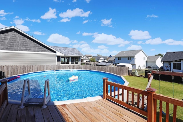 view of pool featuring a residential view, a lawn, a fenced backyard, and a fenced in pool