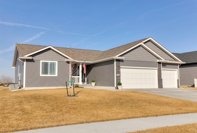 ranch-style house with a front lawn, an attached garage, concrete driveway, and roof with shingles