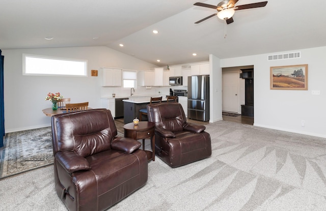 living room with a ceiling fan, baseboards, visible vents, lofted ceiling, and light carpet