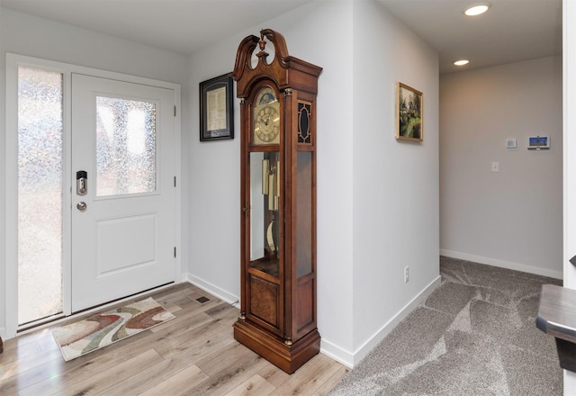 entryway featuring recessed lighting, light wood-style floors, and baseboards