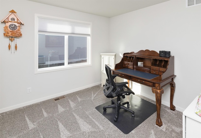 office area with visible vents, baseboards, and carpet