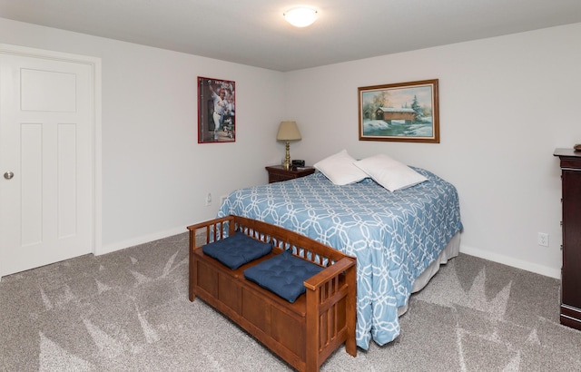 bedroom with baseboards and carpet