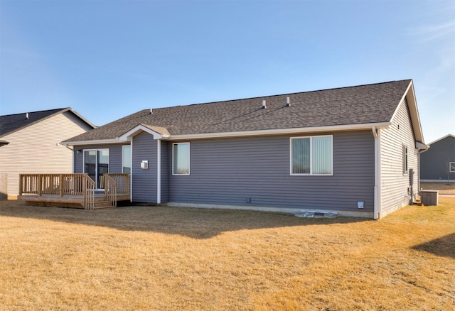 back of house featuring a deck, cooling unit, a yard, and roof with shingles