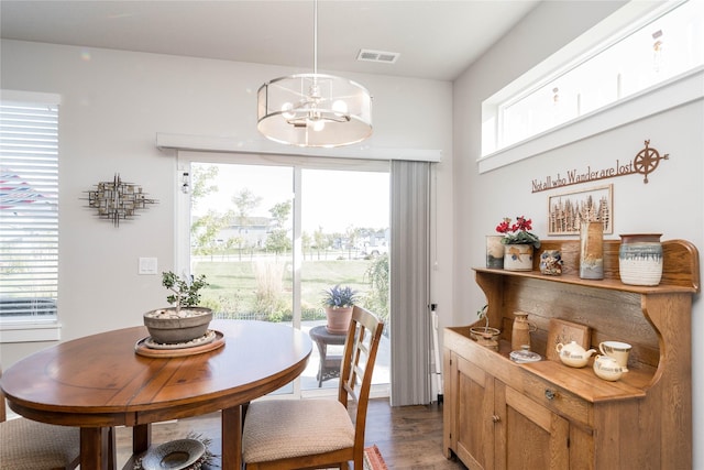 dining space with a notable chandelier, visible vents, and dark wood-style flooring