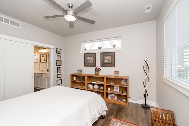 bedroom featuring visible vents, ensuite bathroom, ceiling fan, and dark wood-style flooring