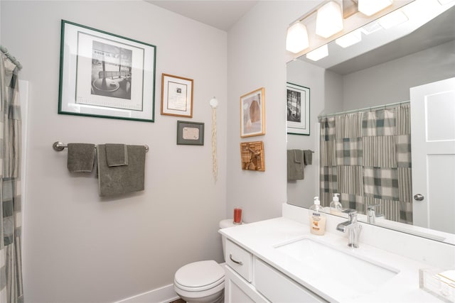 bathroom with toilet, curtained shower, vanity, and baseboards