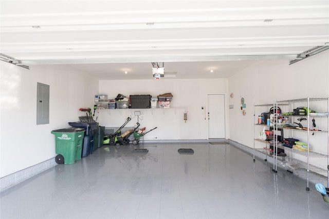 garage with electric panel, a garage door opener, and baseboards