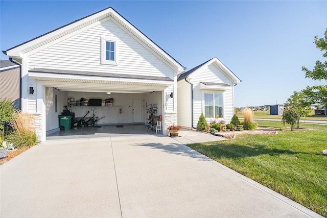 view of front of house featuring concrete driveway and a front yard