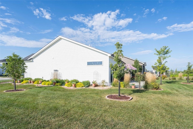 view of side of home with a lawn