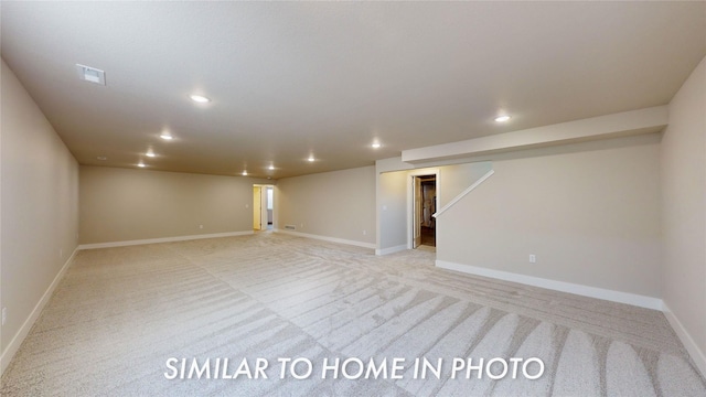 finished below grade area with visible vents, recessed lighting, baseboards, and light carpet