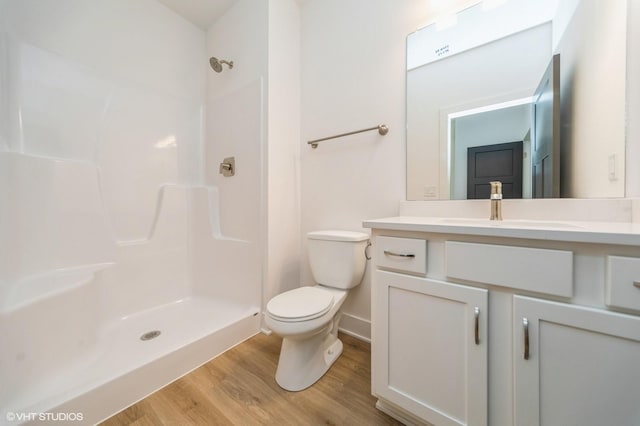 10022 NW 68th Ave, Johnston, IA 50131 - bathroom featuring vanity, wood finished floors, and a shower