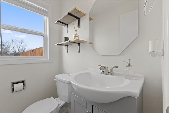 bathroom featuring toilet and vanity