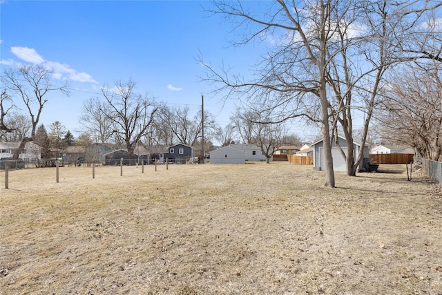 view of yard with a residential view and fence