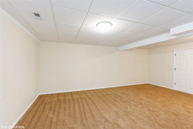 spare room featuring a paneled ceiling, carpet floors, baseboards, and visible vents