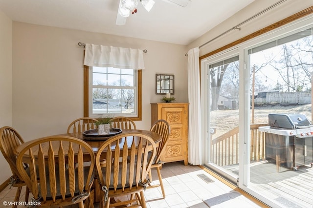 dining space featuring light tile patterned flooring, visible vents, a wealth of natural light, and ceiling fan