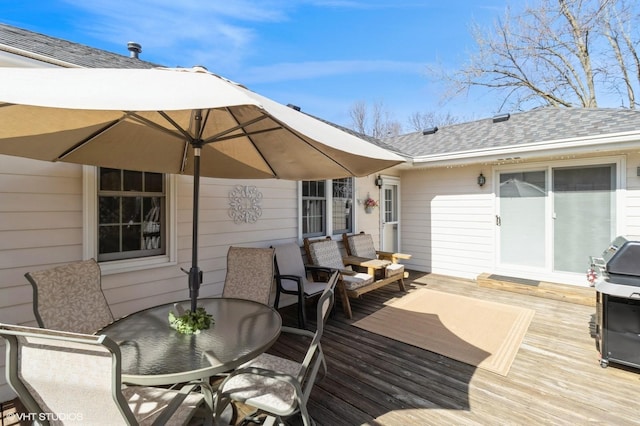 deck featuring a grill and outdoor dining space