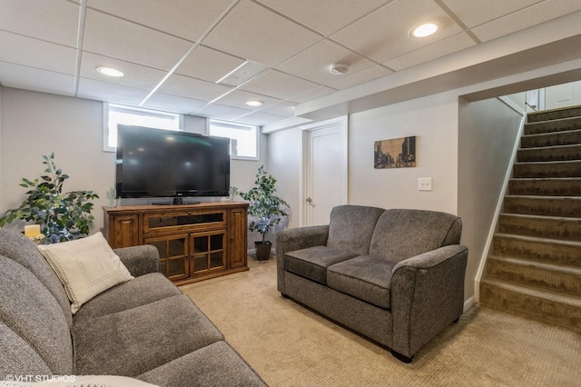 living area with a drop ceiling, stairway, light carpet, and recessed lighting