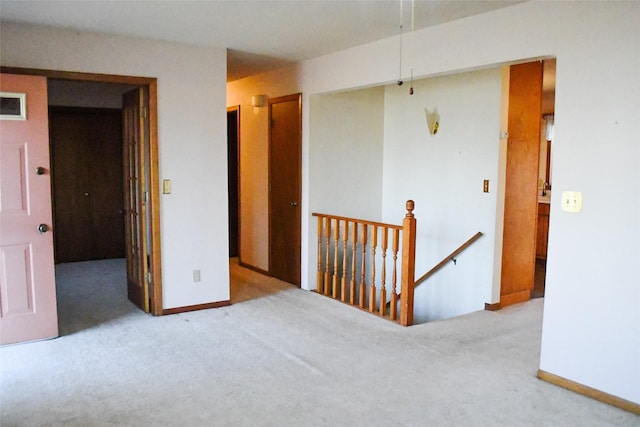 spare room featuring visible vents, carpet, and baseboards