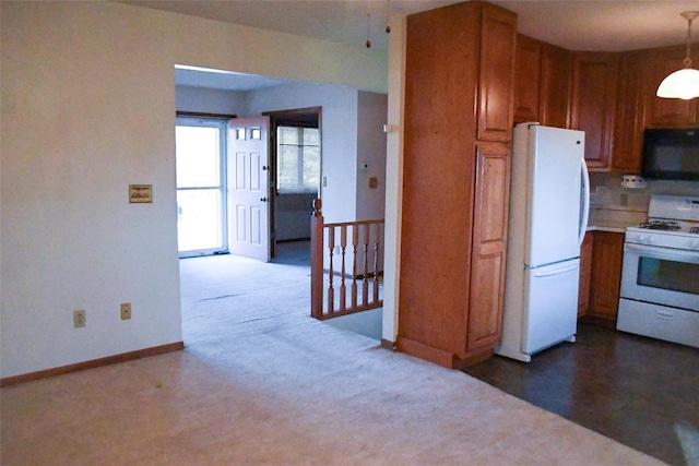 kitchen featuring white appliances, brown cabinetry, baseboards, hanging light fixtures, and light countertops