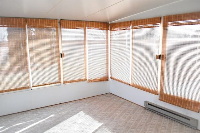 unfurnished sunroom with baseboard heating and vaulted ceiling