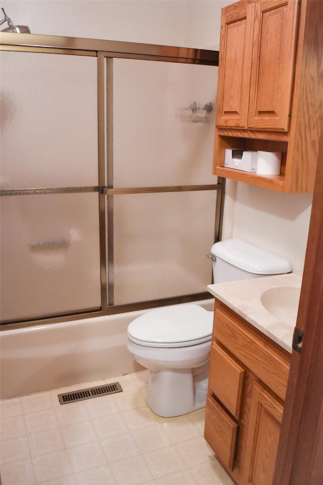 full bathroom featuring combined bath / shower with glass door, visible vents, toilet, and vanity