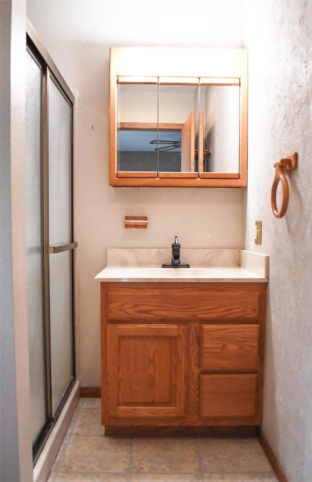 full bath with vanity and a stall shower