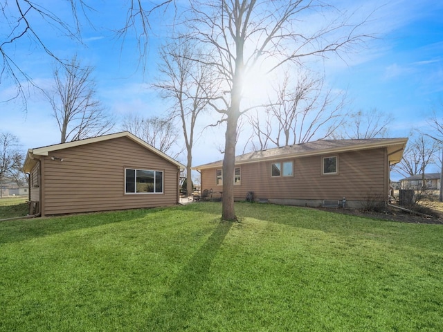 rear view of house featuring a lawn