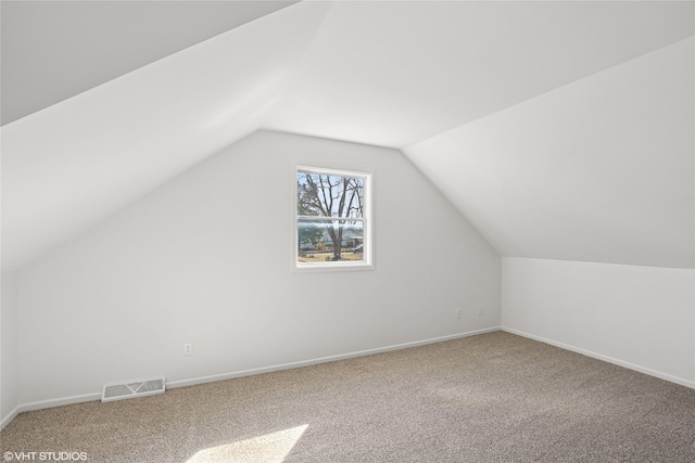 bonus room with vaulted ceiling, visible vents, baseboards, and carpet floors