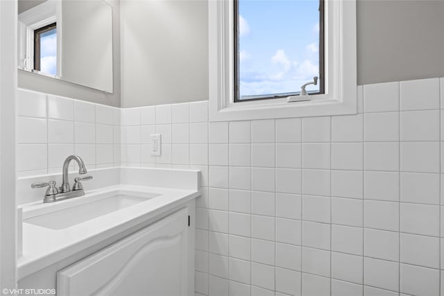 bathroom with tile walls and vanity