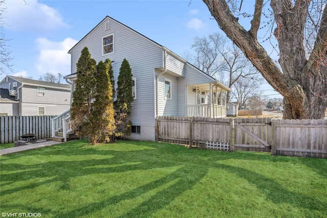 exterior space featuring a yard, a fenced backyard, and a gate