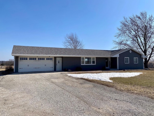 ranch-style home featuring an attached garage and driveway