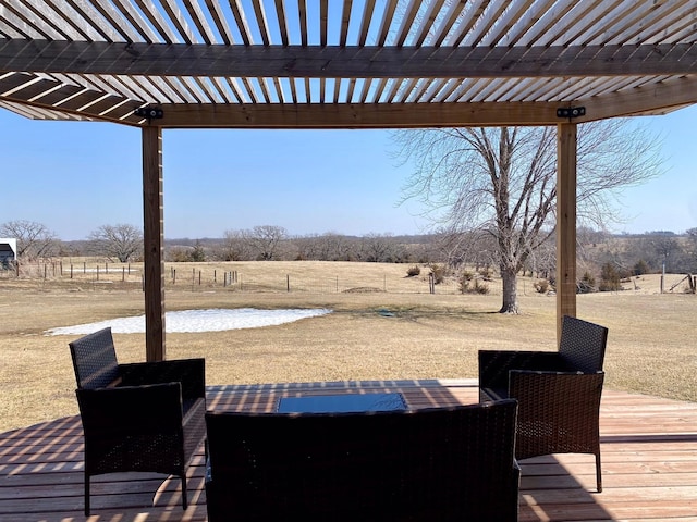 wooden deck with a rural view and a pergola