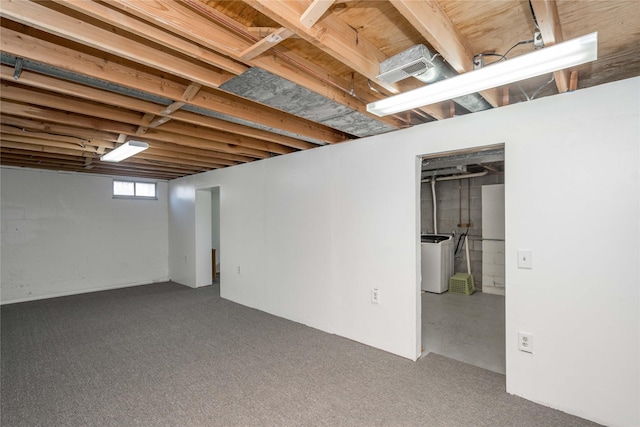 below grade area featuring visible vents, washer / clothes dryer, and carpet