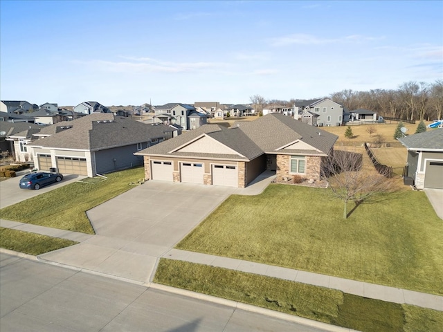 view of front of property with stone siding, a garage, a residential view, and driveway