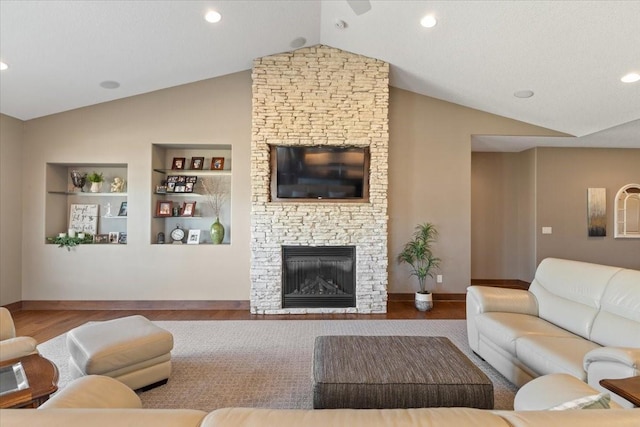 living area with vaulted ceiling, built in shelves, and wood finished floors