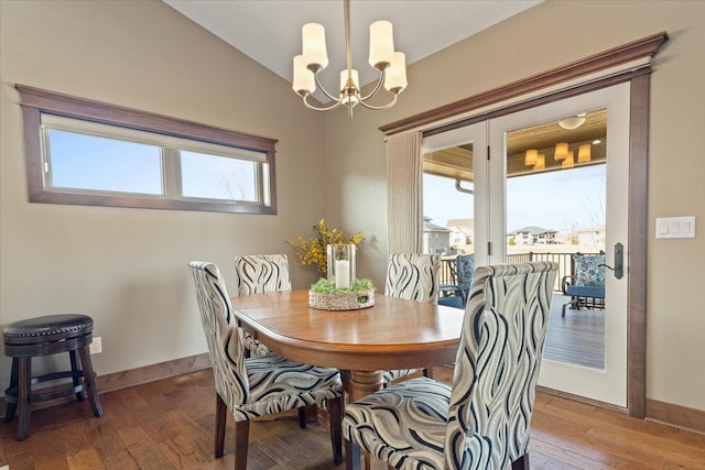 dining room featuring baseboards, a healthy amount of sunlight, a chandelier, and hardwood / wood-style flooring