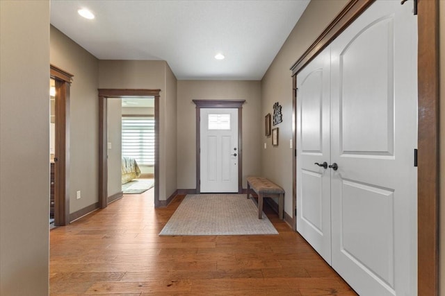 foyer with recessed lighting, wood finished floors, and baseboards