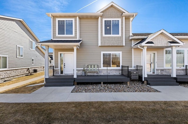 craftsman-style home featuring stone siding