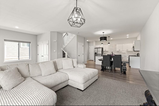 living room featuring recessed lighting, stairway, and wood finished floors