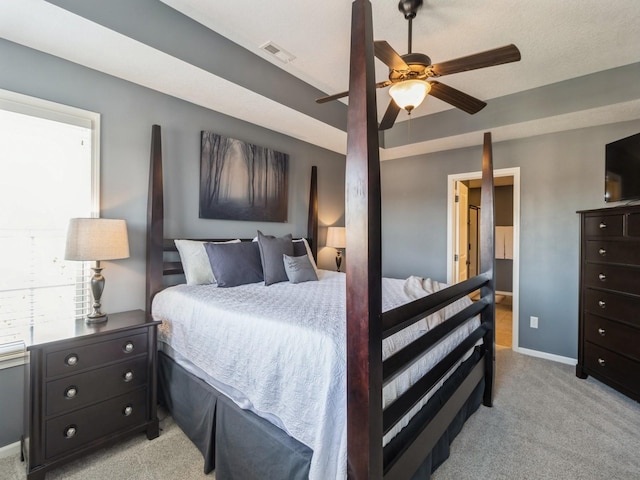 bedroom featuring light carpet, visible vents, a ceiling fan, and baseboards