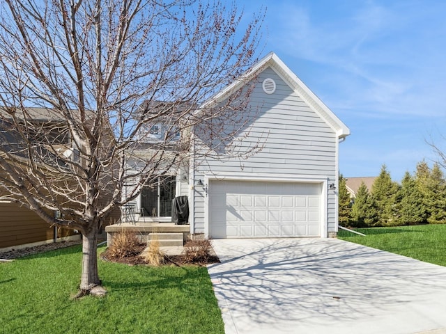 traditional-style house with a front lawn, a garage, and driveway