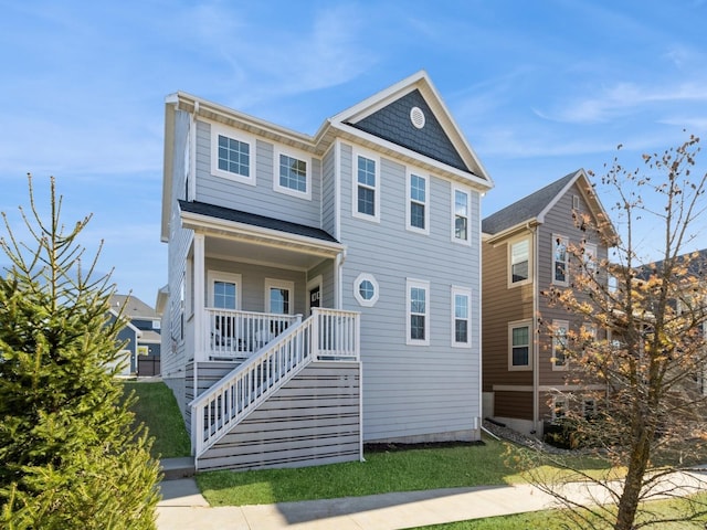 view of front of property featuring stairway and covered porch