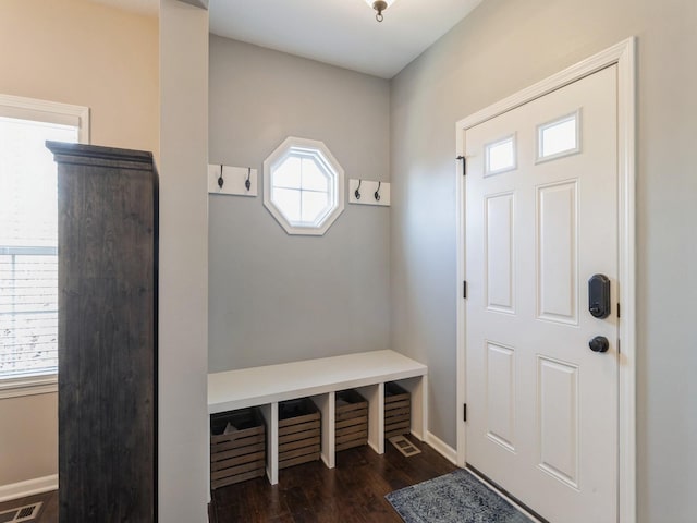 mudroom featuring visible vents, baseboards, and dark wood-style flooring