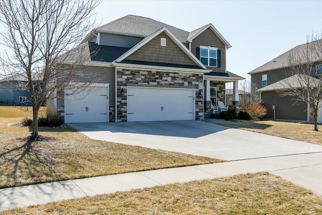 craftsman house with stone siding, driveway, a shingled roof, and a garage