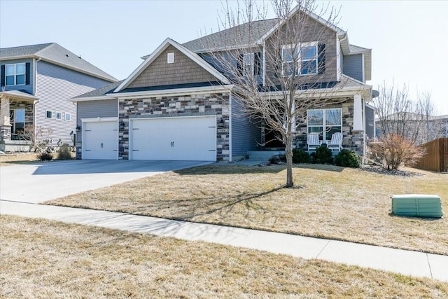 craftsman-style home with an attached garage, a porch, a front yard, stone siding, and driveway