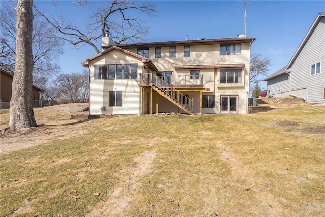 back of property with a deck, stairway, a lawn, and a chimney