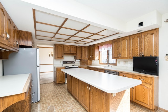 kitchen with a kitchen island, brown cabinets, stainless steel appliances, and a sink