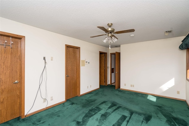 unfurnished bedroom featuring carpet flooring, baseboards, and a textured ceiling