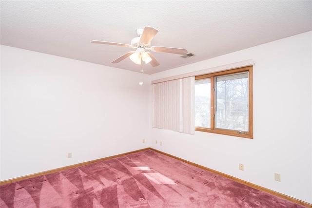 unfurnished room featuring a ceiling fan, baseboards, visible vents, carpet floors, and a textured ceiling