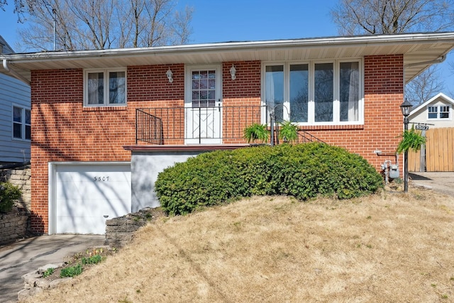 ranch-style home featuring an attached garage, brick siding, and driveway